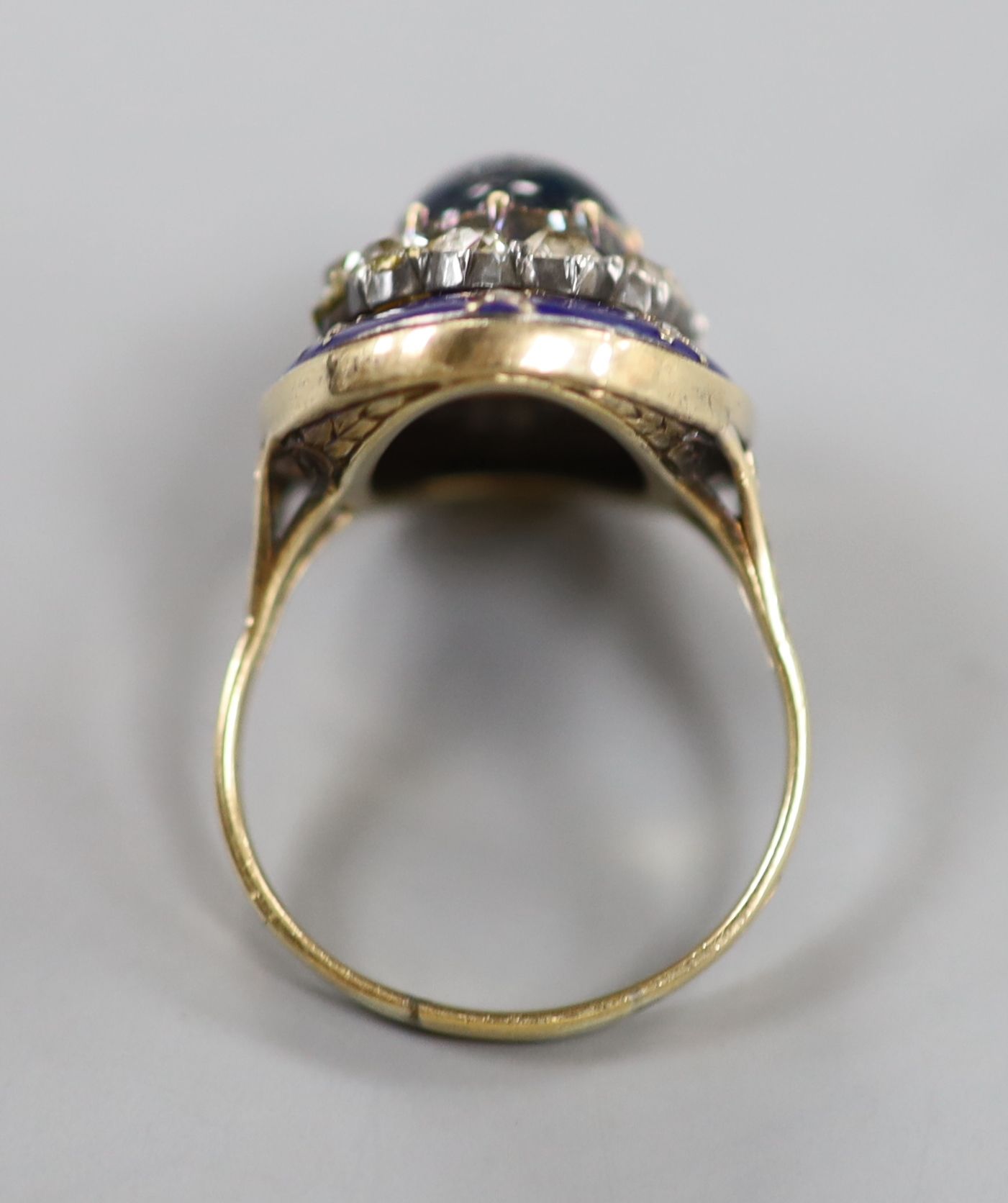 A 19th century French yellow metal (18ct poincon mark), cabochon sapphire, rose and old cut diamond and blue enamel set oval dress ring